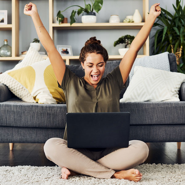 Young woman celebrating receiving mortgage offer