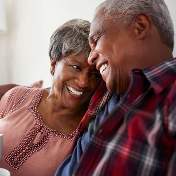 Older couple smiling at home in Mold