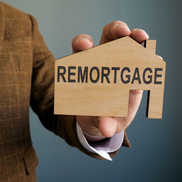 Mortgage adviser holding up remortgage sign